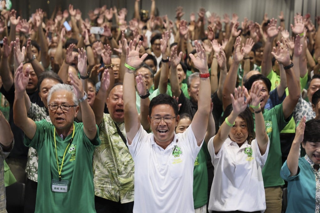 Genta Koja (centre) celebrates with his supporters in Naha, Okinawa, after reports projected his victory in the prefecture's gubernatorial election on September 13. Photo: AFP