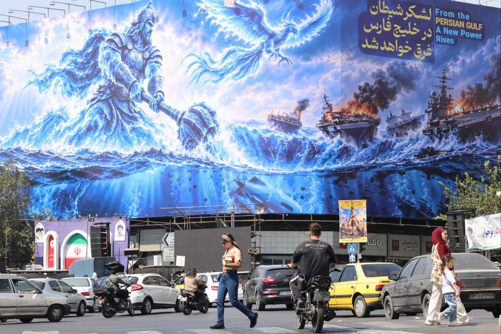 Iranian commuters pass a huge anti-US billboard reading in Persian, “The devil army will be drowned in the Persian Gulf”, erected on Enghelab Square in Tehran, on Monday. Photo: AFP