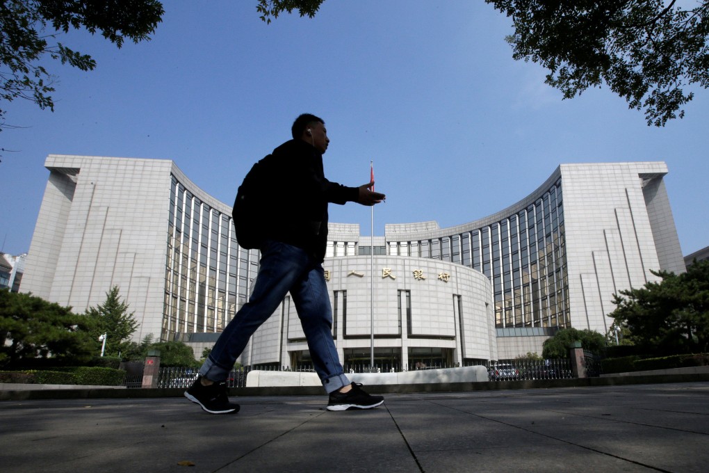 A man walks past the headquarters of the People’s Bank of China, the central bank, in Beijing. Photo: Reuters