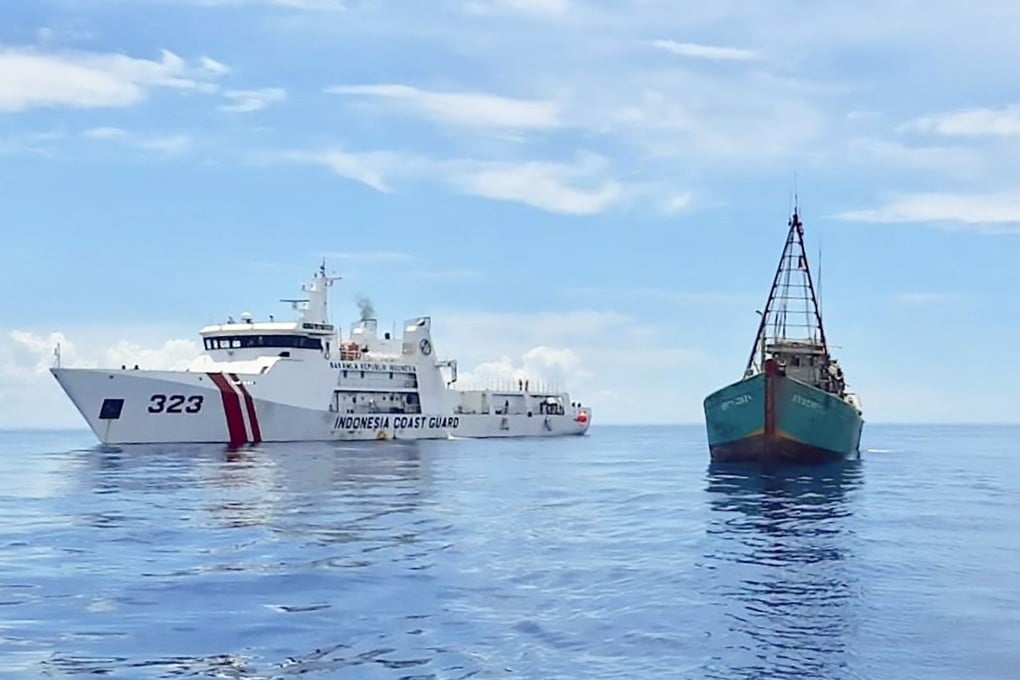 An Indonesian coastguard ship sails next to a Vietnamese fishing vessel near Indonesia’s Natuna Islands in July 2020. Chinese, Vietnamese and Indonesian fishing boats have occasionally clashed over marine resources in the area. Photo: AFP