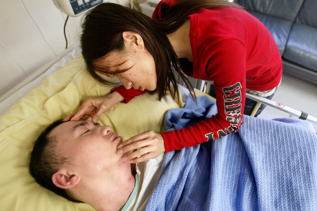 Jacky Chu in hospital in 2006, with his wife, Choi Yin Ping, by his side. Photo: SCMP