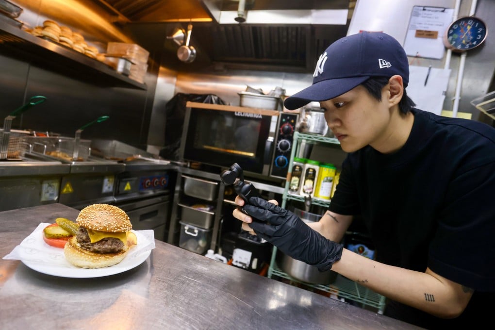Mel Ng records video of a Diplomat Burger that she prepped at The Diplomat in Central, Hong Kong. The Diplomat was the 31st stop in Ng’s stagiaire series on Instagram. Photo: Jonathan Wong