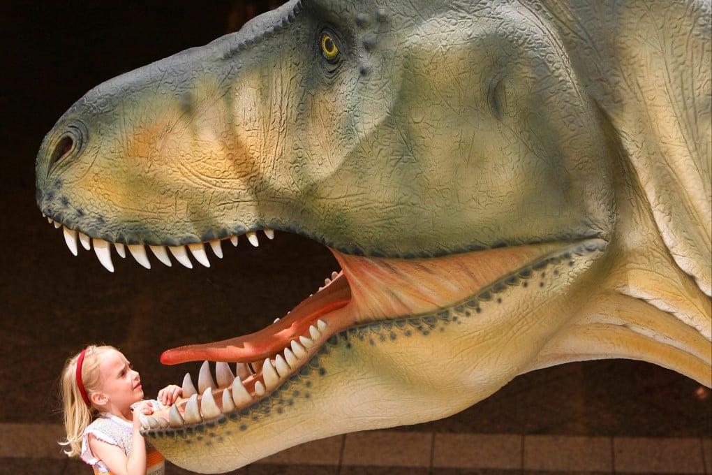 A child looks into the mouth of a Tyrannosaurus rex model at an exhibition in Jena, Germany, in June 2006. Photo: AP