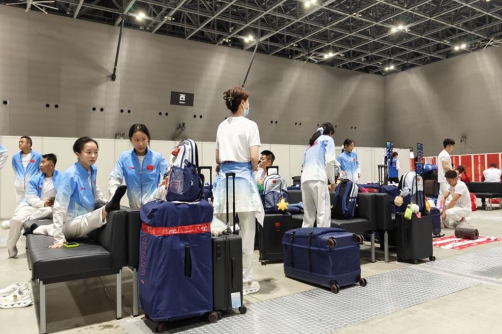 Members of the Chinese gymnastics team try and stay relaxed during their long wait Nagoya airport. Photos: Xinhua