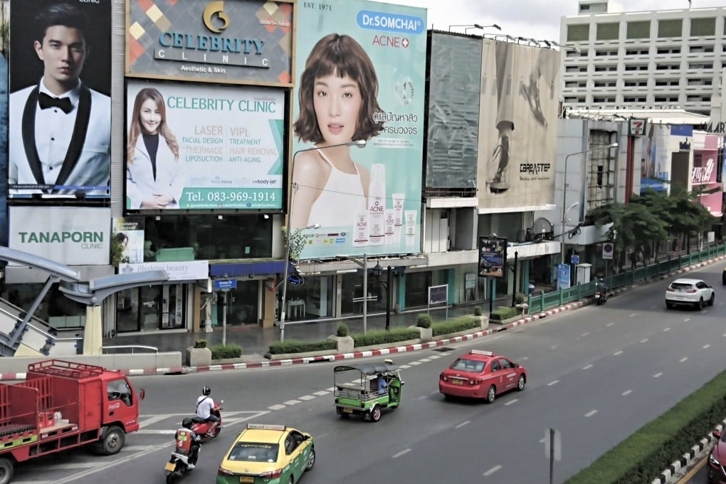 Billboards feature advertisements for beauty clinics in central Bangkok. Photo: Tibor Krausz
