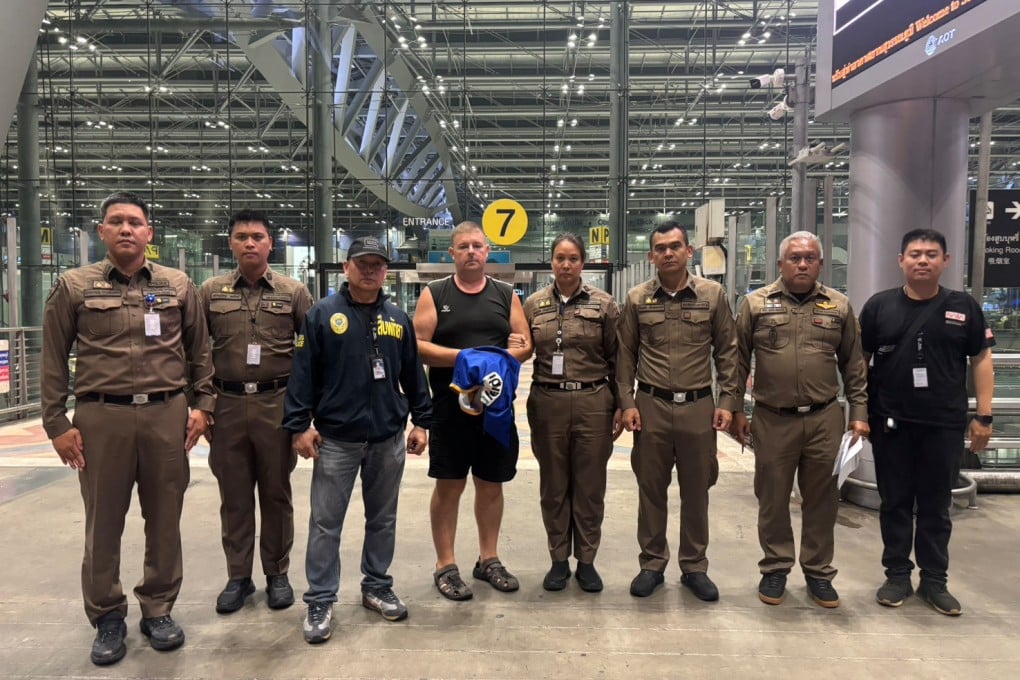 Australian Simon Peter Carman (fourth from left) after being arrested at an airport in Thailand on June 26. Photo: Pattaya Provincial Police via AP