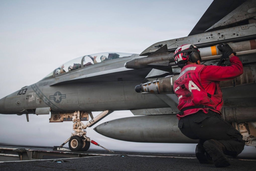 A US sailor checks ordnance on an F/A-18 Super Hornet aboard Nimitz-class aircraft carrier USS George Washington on September 13. Photo: US Navy / AFP