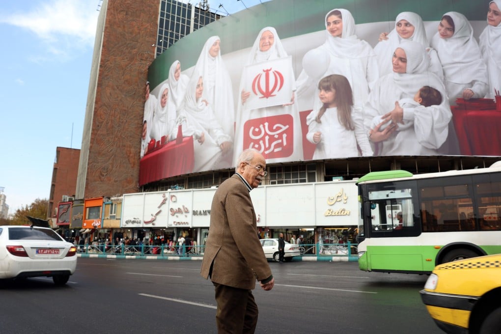 An elderly Iranian man walks past a billboard in Tehran. Many Iranians are struggling to get the medicines they need, due to the war. File photo: EPA