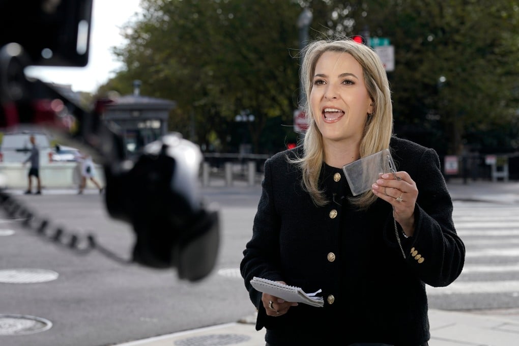 CNN Senior White House Reporter Betsy Klein, holding up an empty credential holder, reports near the White House complex on Saturday. Photo: AP