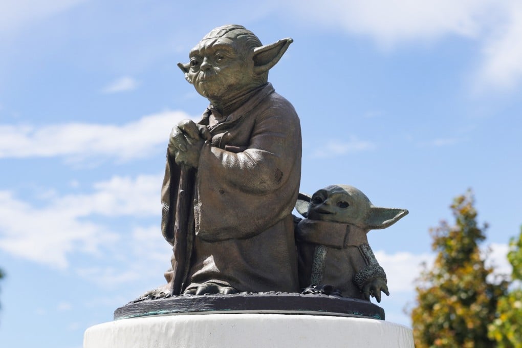 A statue of Yoda and Grogu from the Star Wars franchise stands in the courtyard outside the Lucas Museum of Narrative Art at Exposition Park in Los Angeles, California. Photo: EPA