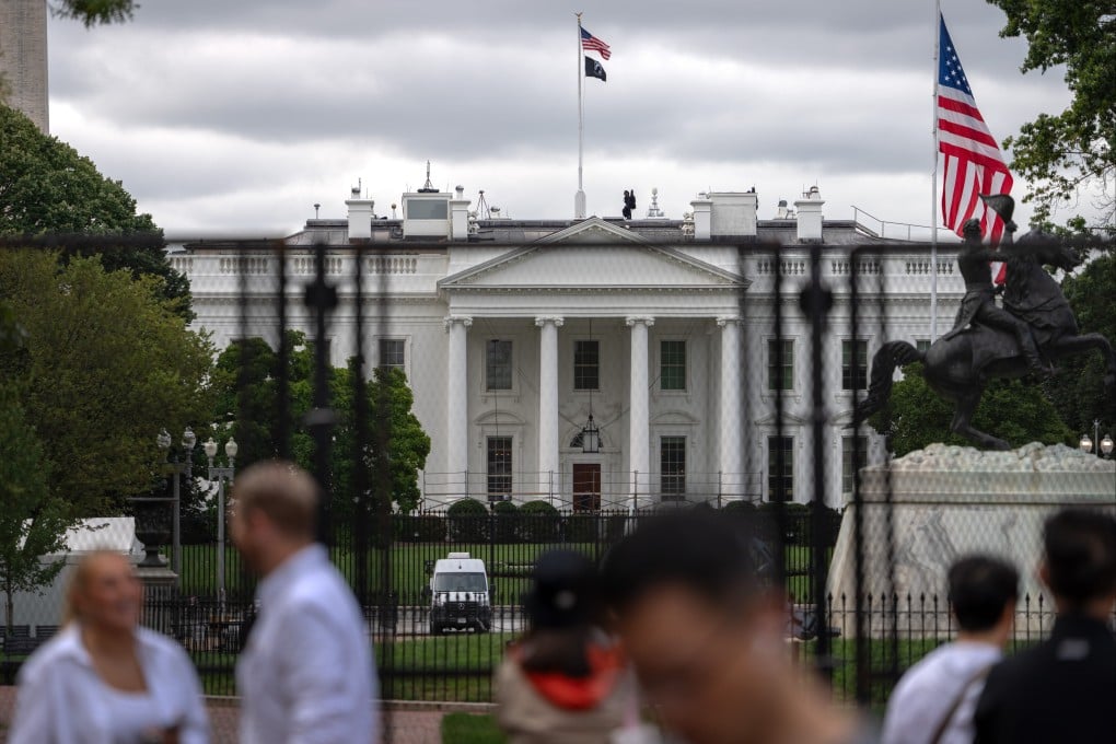 Tourists gather near the White House on Monday, the day three news outlets said they were suing the government over moves to ban them from the building and its grounds. Photo: AP