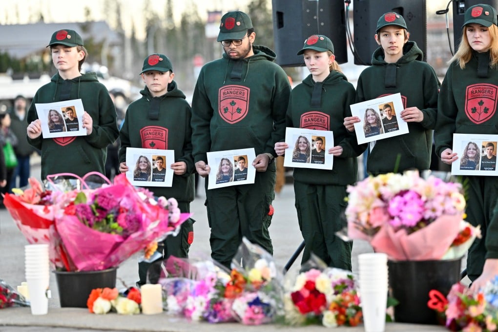 Children hold pictures of victims of the mass shooting in Tumbler Ridge, Canada earlier this year. Photo: Reuters
