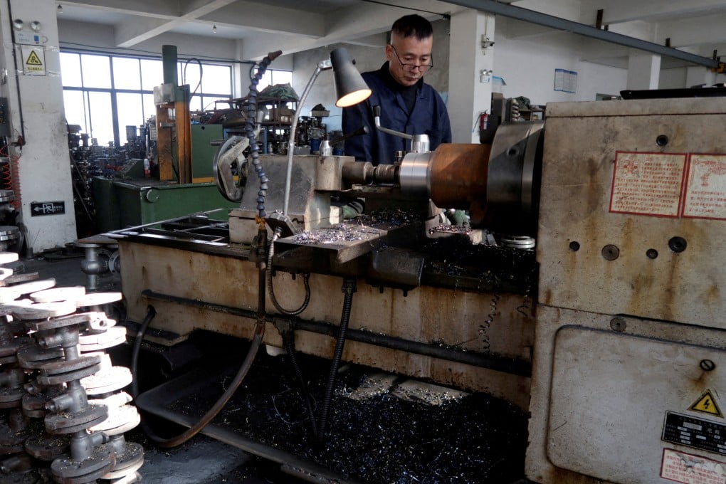 An employee works on the production line manufacturing pipe-fitting valves at a factory in Wenzhou in eastern Zhejiang province. Photo: Reuters