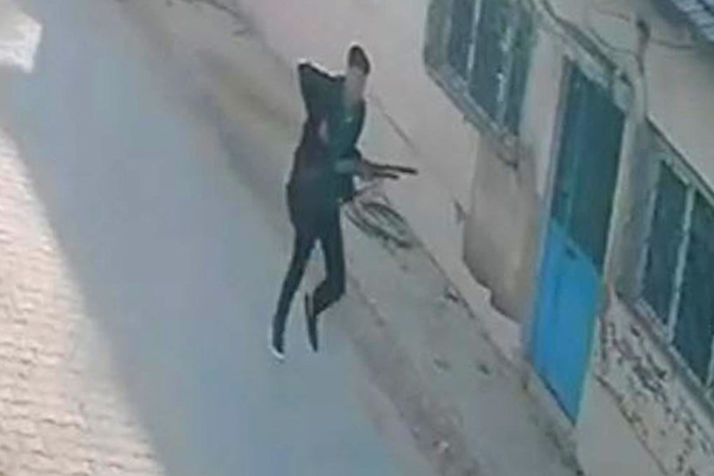 This handout photograph taken and released on Tuesday shows a CCTV image of a gunman running near a school in Turgutlu, an area west of the resort city of Izmir, before a shooting outside a school. Photo: via AFP/DHA