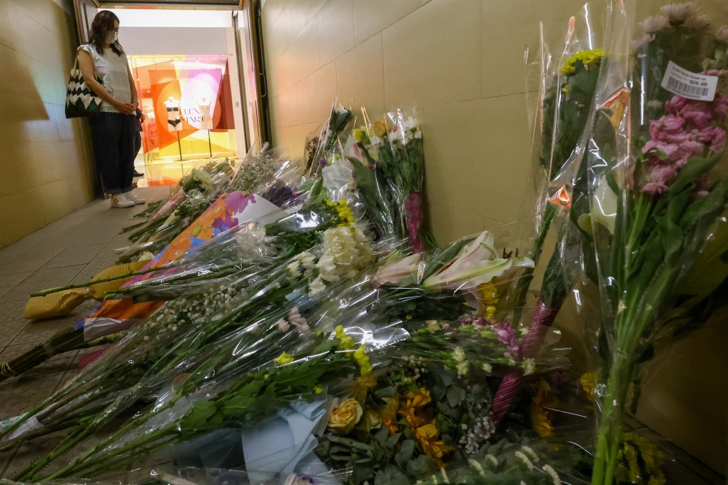 People lay flowers in memory of the two victims who were fatally stabbed at the Plaza Hollywood shopping centre in Diamond Hill in early June 2023. Photo: Dickson Lee