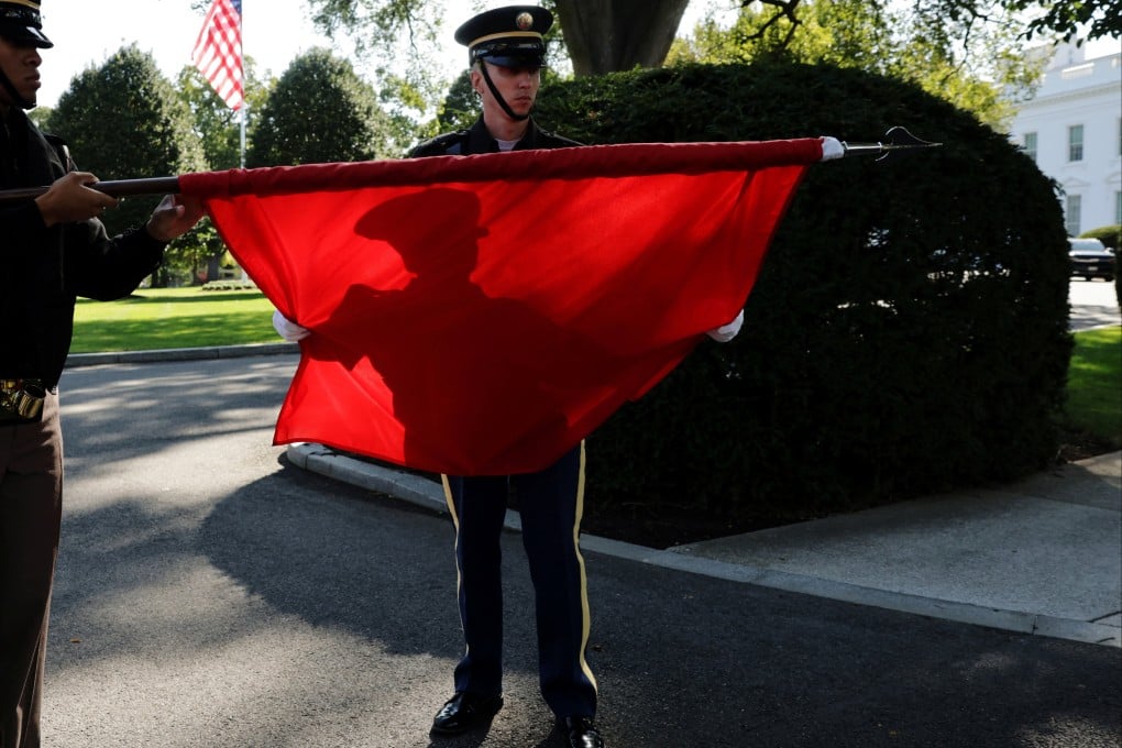 Members of a US military honour guard roll up a Chinese flag in Washington after rehearsing for Chinese President Xi Jinping’s state visit this week. Photo: Reuters