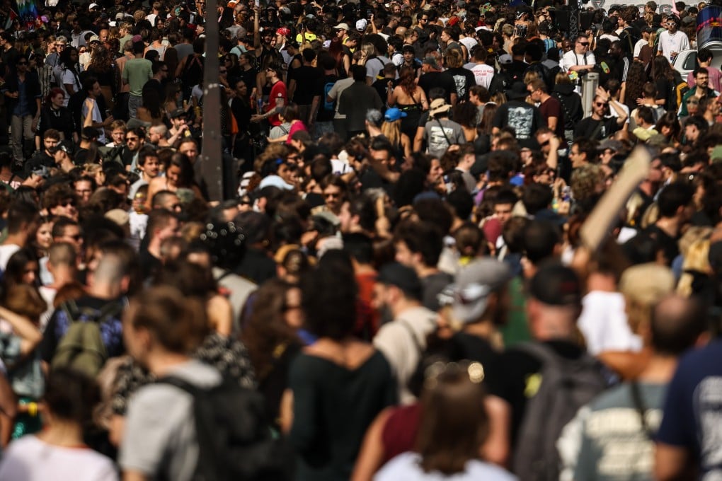 Crowds gather in the streets of Paris. French authorities have opened several privacy investigations into the growing practice of secretly recording women in public spaces using smart glasses. Photo: AP