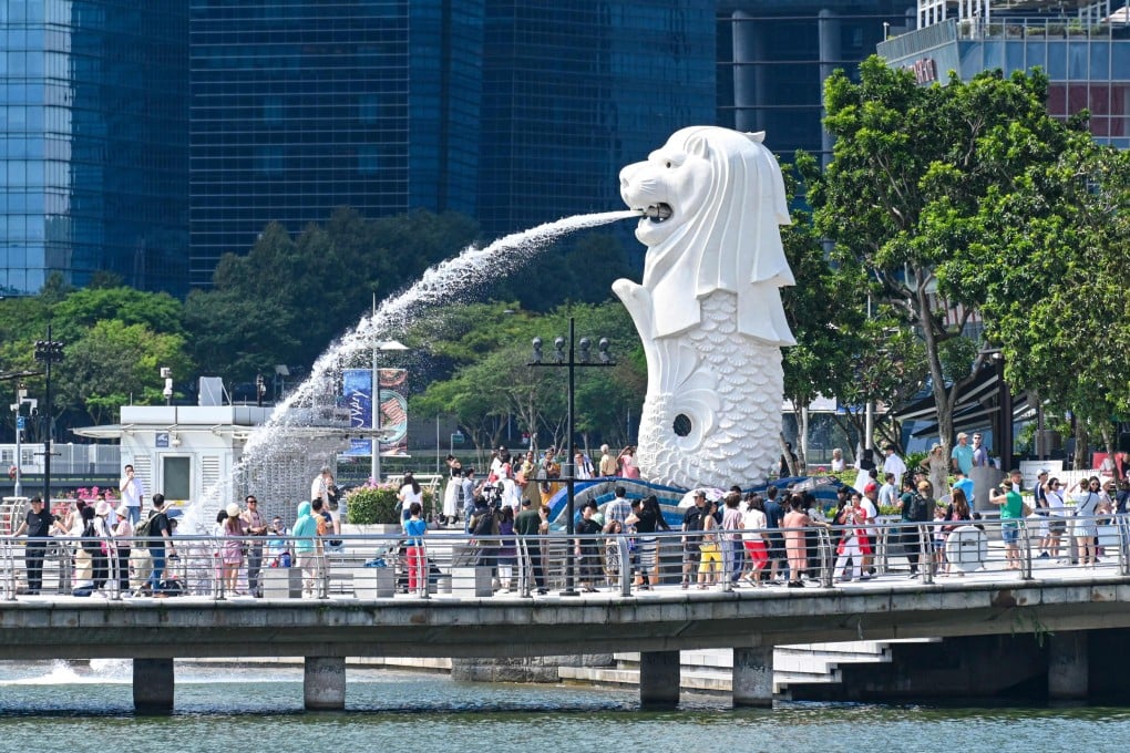 People gather next to the Merlion statue at the Marina Bay waterfront in Singapore. Photo: AFP