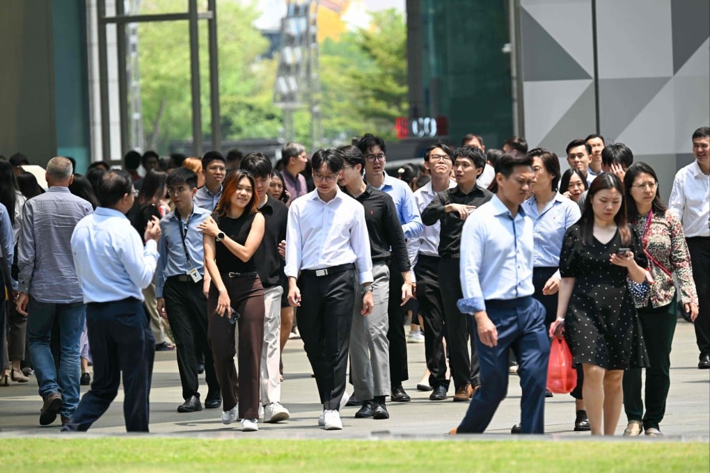 People walk out during lunch time at the financial business district of Raffles Place in Singapore on September 9. Photo: AFP