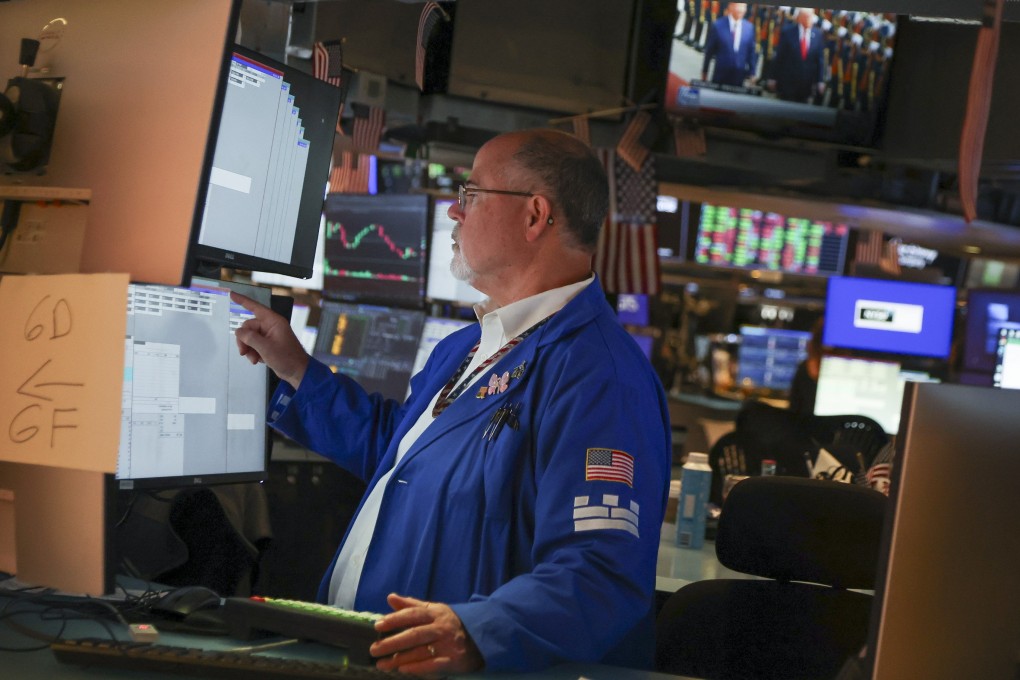 A trader works on the floor of the New York Stock Exchange on Monday. The Nasdaq-100 Index hit a record high on Tuesday. Photo: EPA