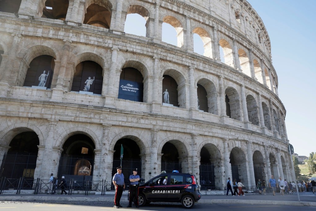 Carabinieri paramilitary police stand on patrol outside the Colosseum in Rome on Wednesday. Photo: via AP