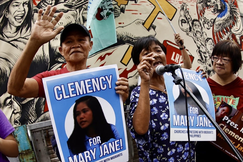 The parents of Mary Jane Veloso holding placards demanding clemency for their daughter during a protest in Manila in November 2024. Photo: EPA