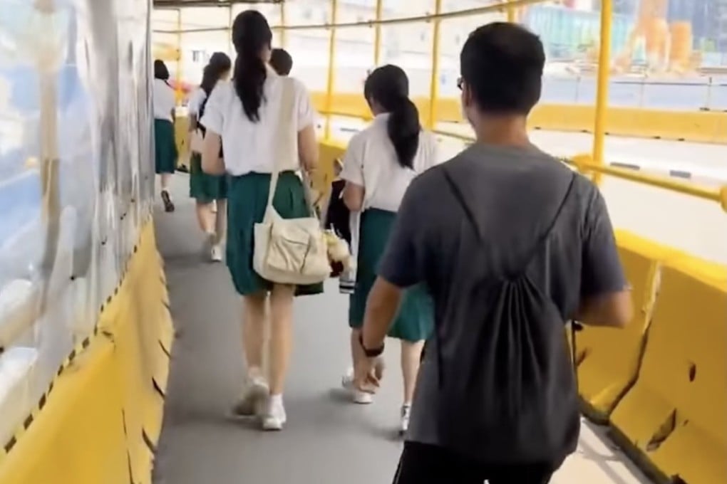 A man wearing black-rimmed glasses and a face mask is seen walking behind two female students in Singapore. Photo: Reddit/Bblackjack160
