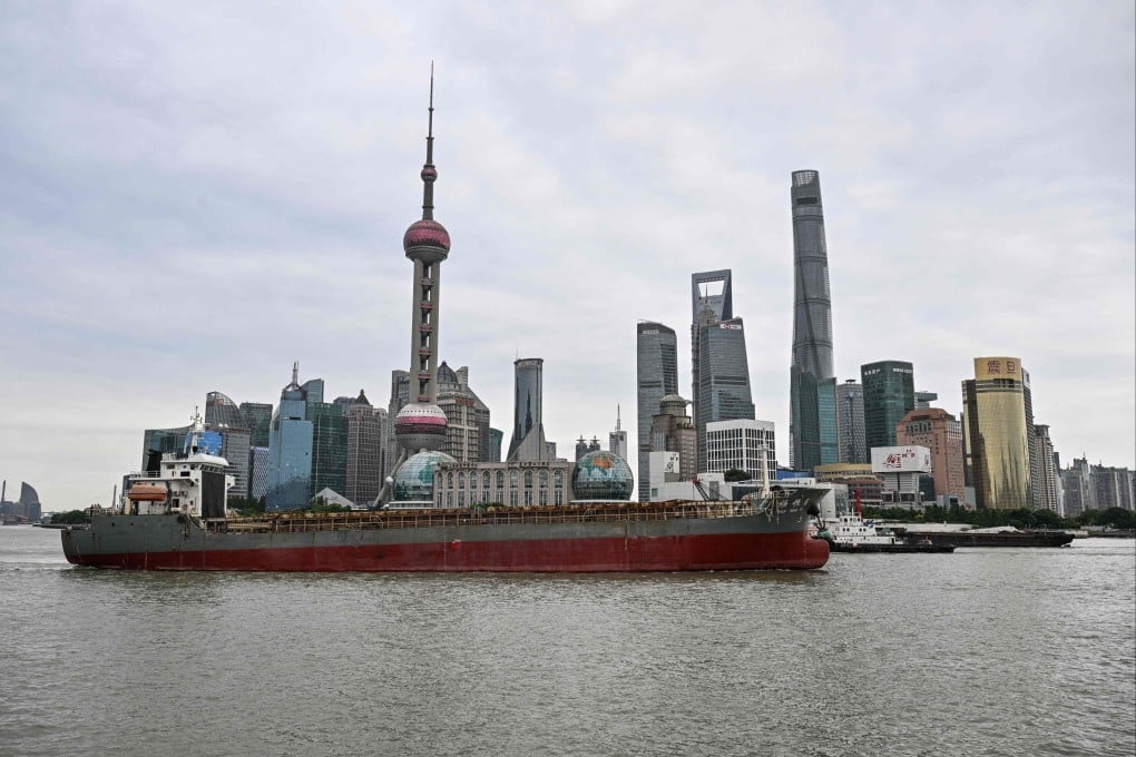 A cargo ship sails along the Huangpu River in Shanghai on September 23. The last time President Xi Jinping was in the US for a state visit in September 2015, China’s markets were in turmoil. This is not the case today. Photo: AFP