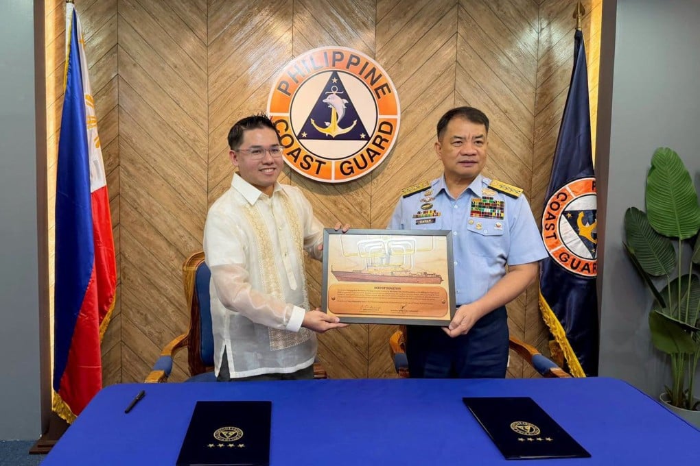 Admiral Ronnie Gil Gavan (right), commandant of the Philippine Coast Guard, receives the formal deed of donation for the 61-metre vessel from WPS Foundation CEO Jeffrey Ordaniel, in Manila on September 21. Photo: Handout