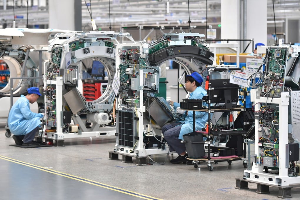Workers assemble CT machines at Neusoft Medical’s factory in Shenyang, Liaoning province. Photo: Xinhua