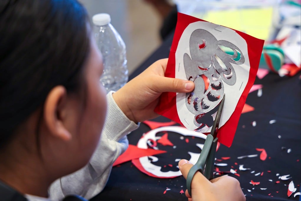 A woman practises paper cutting to celebrate the Mid-Autumn Festival in Santa Ana, California, on September 13. Photo: Xinhua
