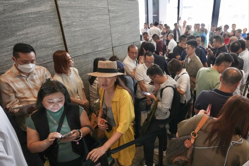 People queue at a sales centre in Quarry Bay to buy flats at the new State Residence project in North Point on Saturday. Photo: Karma Lo