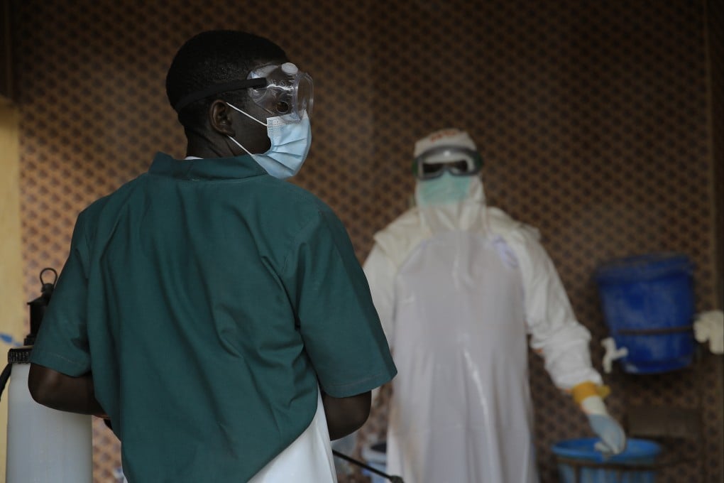 A healthcare worker is disinfected by his colleague inside a treatment centre for Ebola patients in North Kivu province in eastern Congo on Saturday. Photo: AP