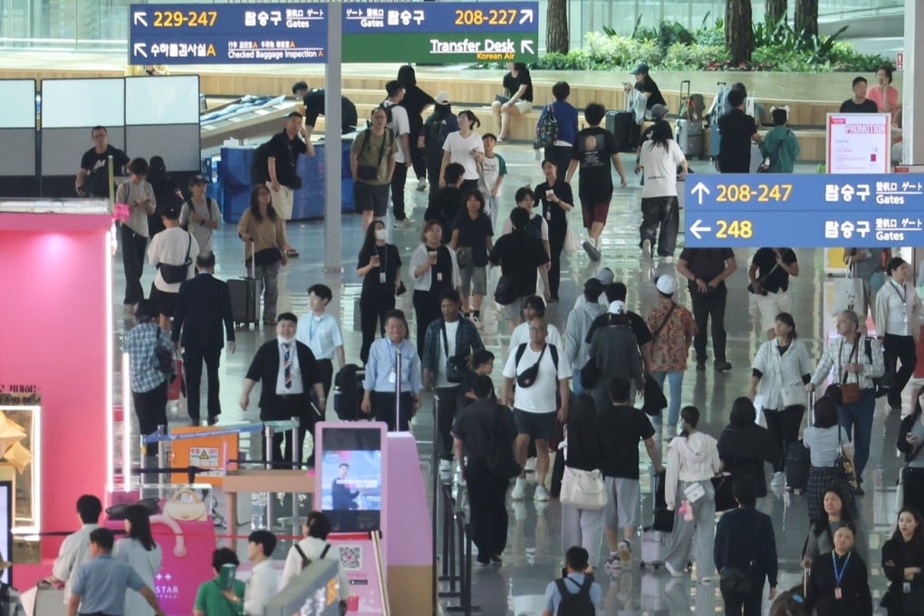 Travellers move through the duty-free area of Incheon International Airport on July 7. Photo: Yonhap / EPA