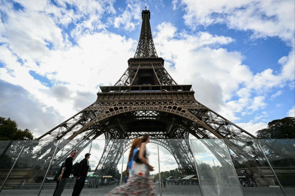 Pedestrians walk past the Eiffel Tower in Paris on September 8. Photo: AFP