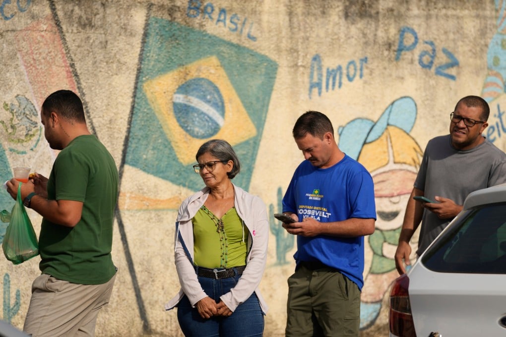 Voters queue at a polling station during general elections in Brasilia, Brazil on Sunday. Photo: AP