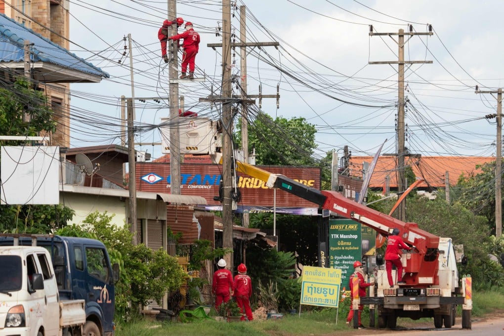Electrical technicians carry out maintenance work in the Hadxayfong district of Vientiane, Laos, in August. Photo: AFP