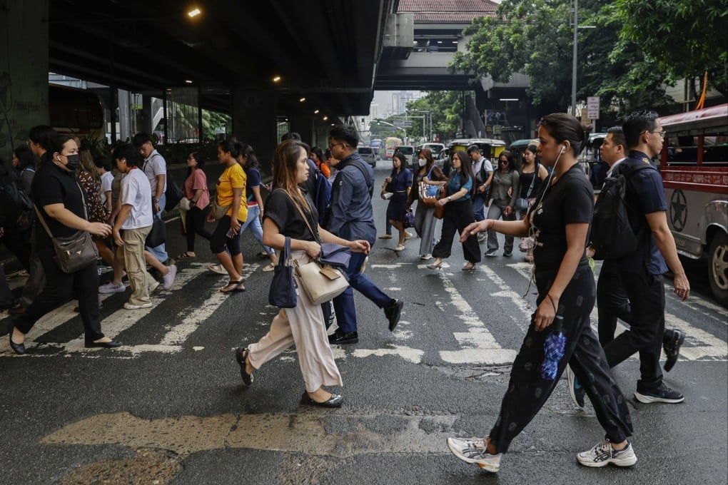 People cross an intersection in Manila. The Asian Development Bank Institute has urged the Philippines to provide targeted support for the middle class to protect its purchasing power. Photo: EPA