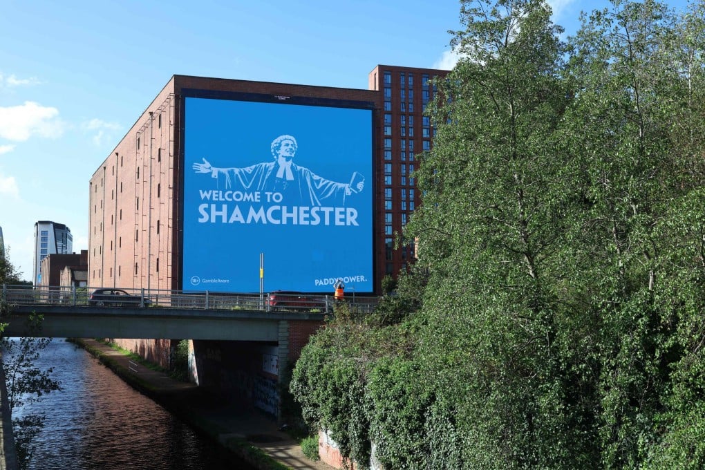 An advertisement billboard for the betting company Paddy Power, reading “Welcome to Shamchester”, is displayed in Manchester, England, on October 1. Photo: AFP