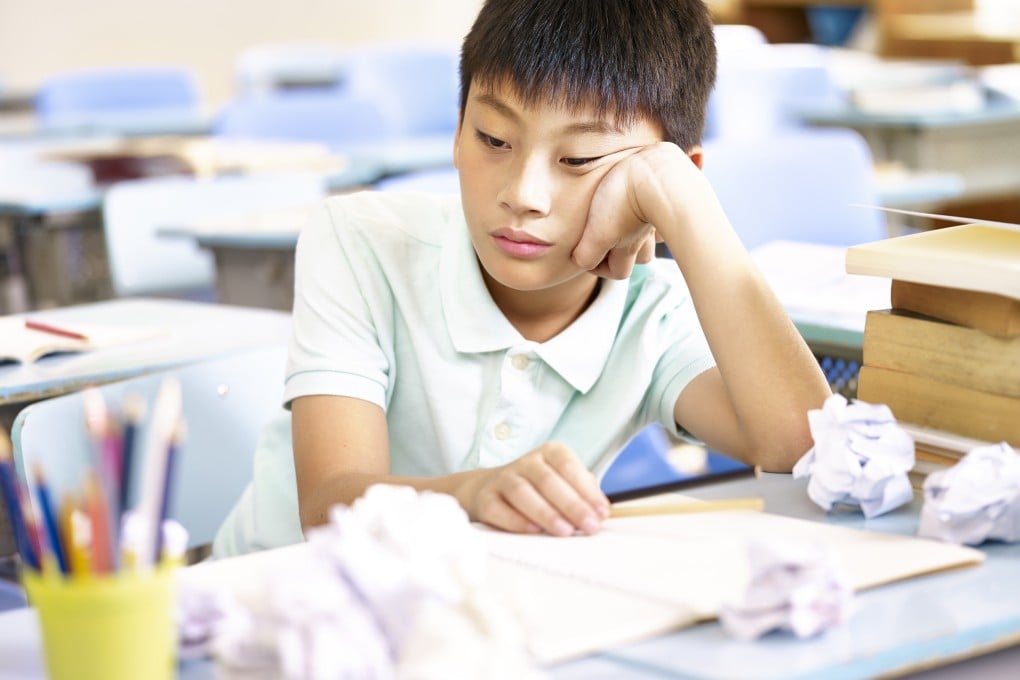 A student sits at a desk during a class. Academic pressure and long studying hours are a major source of stress for youth across Asia. Photo: Shutterstock
