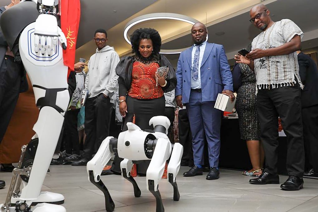 Guests interact with a robot dog during an event to celebrate Chinese New Year in Johannesburg, South Africa in February. Photo: Xinhua