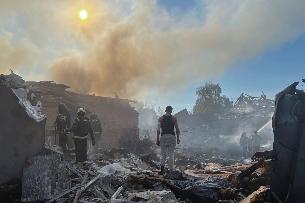 An injured man stands amid rubble as firefighters work at the site of his house hit by a Russian air strike in Kharkiv, Ukraine on Sunday. Photo: Reuters