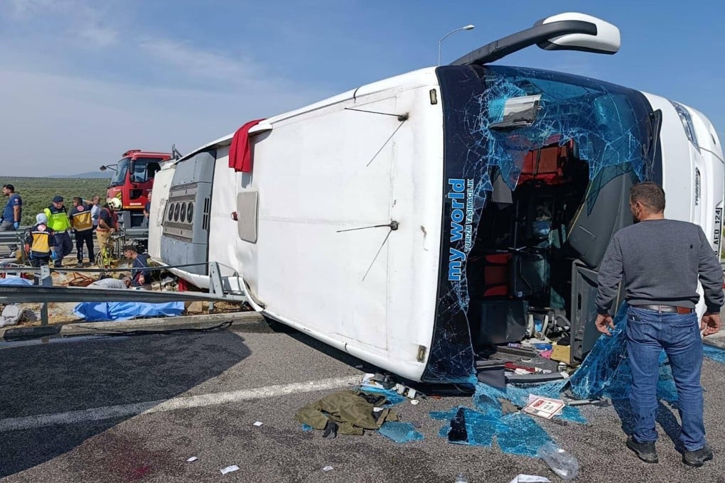 Fire department and first aid officials at the site of a crash in Manisa, western Turkey on Sunday after a tour bus and a lorry collided. Photo: Handout / DHA (Demiroren News Agency) / AFP