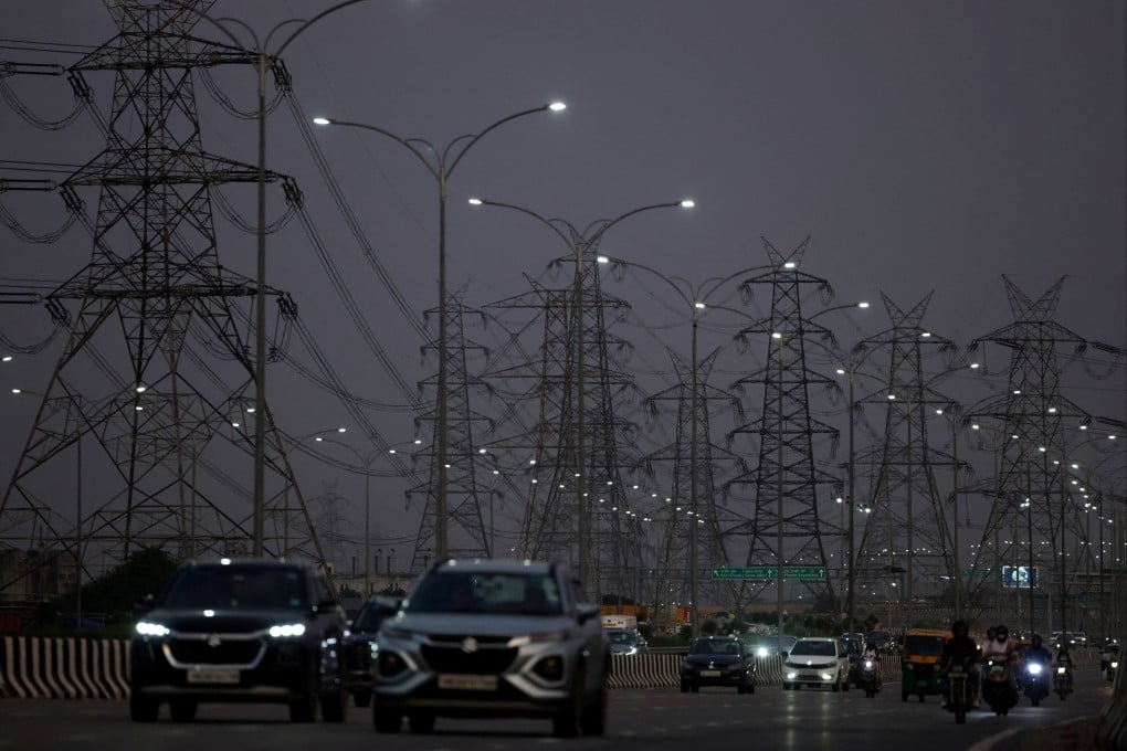 Vehicles move past electricity pylons in Gurugram, India. The nation is struggling to keep up with energy demands. File photo: Reuters