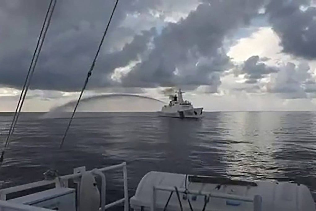 A screengrab shows a Chinese coastguard ship firing its water cannon next to a Philippine coastguard ship during a medical evacuation of a Philippine Navy personnel near Second Thomas Shoal in the South China Sea on October 8. Photo: Philippines Coast Guard / AFP