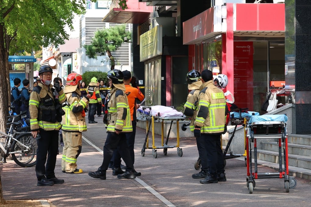 Police officers and firefighters gather outside a shopping centre following a stabbing attack in Incheon, South Korea, on Tuesday. Photo: AP