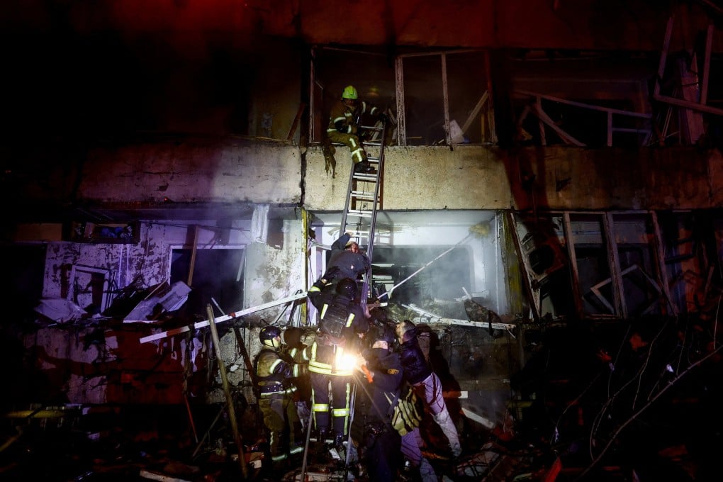 An injured man climbs down a ladder at a Kyiv residential building hit in a Russian missile strike on Tuesday. Photo: Reuters