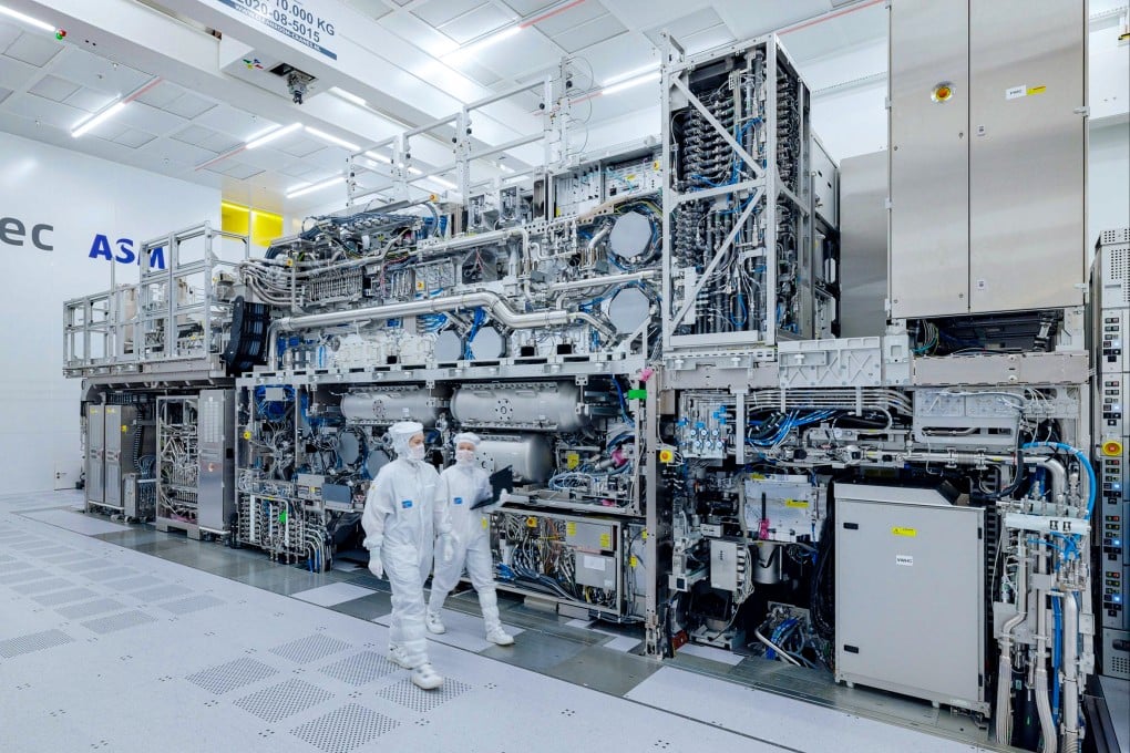 ASML engineers walk past an extreme ultraviolet (EUV) chipmaking machine at a company facility in Veldhoven, the Netherlands. Photo: Handout