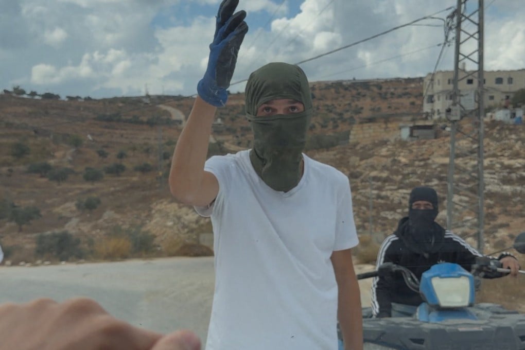 Masked people are seen at the site of an alleged attack on Western diplomats and officials in Taybeh on Saturday. Photo: Amit Orfali via Reuters