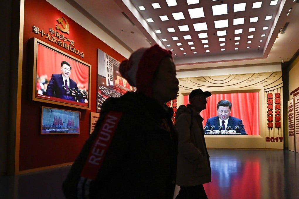 Visitors walk past portraits of President Xi Jinping at the Museum of the Communist Party of China in Beijing on March 1. Photo: AFP